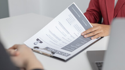 Employer or HR department is reading the resume and interviewing the ability of new employees, Employer is selecting job applicants, Employment and Recruitment Concept.