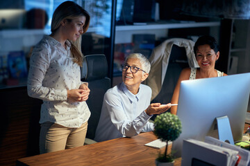 Group of cheerful successful business woman at work