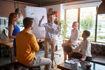 Senior female partner leading company meeting