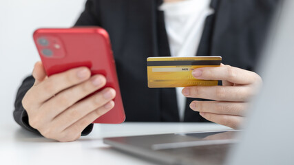Businesswoman use mobile phones to register for security Online with a credit card to buy products online through application, Online shopping or Internet technology concept.