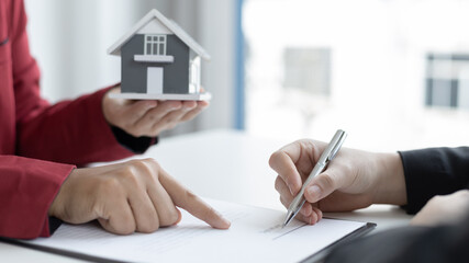 Signing a home purchase contract, sales manager has proposed terms and conditions to customers who sign house purchase agreements with insurance, Agreement to sign the purchase contract concept.