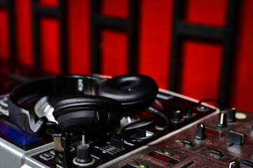 Fototapeta na wymiar The DJ's headphones are on the audio mixer