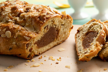 Traditional Dutch homemade easter bread and slices stuffed with almond paste, cinnamon and almonds close up 