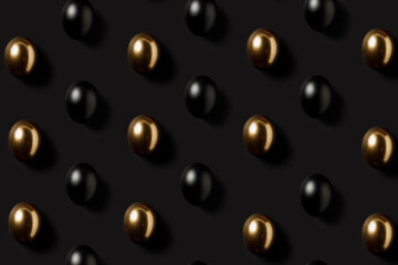 Black and gold eggs pattern over dark black background. Minimal black luxury Easter concept. Trendy layout representing investments, savings and pensions. Flat lay, top view.