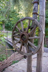 Old wooden wheel from a cart, village traditions