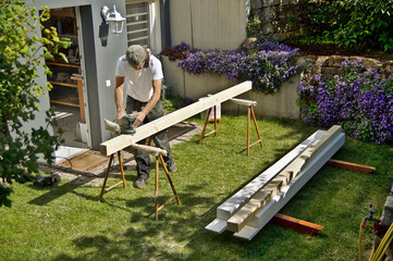 Preparation grinding woodwork outside. working with a random orbital sander in spring. Carpentry...