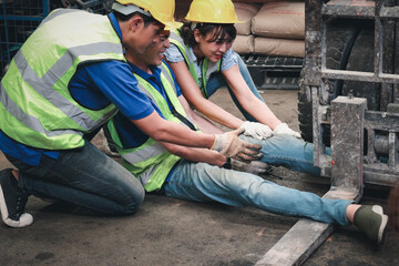 Accident at workplace, industrial engineer worker wearing helmet hit by forklift car at...