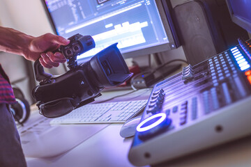 Professional cutting room for video editing and video producing: Monitors, camera and sound mixing