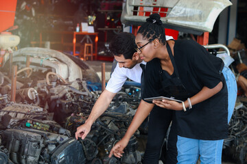 Happy Harmony people at workplace, smiling white man and African American worker working together a, two people checking product stock at auto spare parts store shop warehouse 
