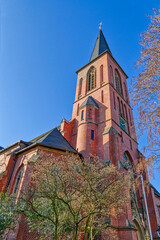 Fototapeta na wymiar Historischer Kirchturm in Düsseldorf Eller