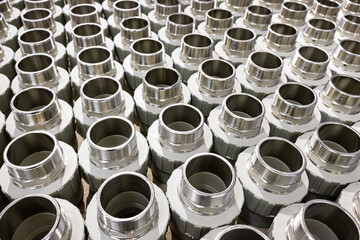 many metal pipe couplings in a pipe factory