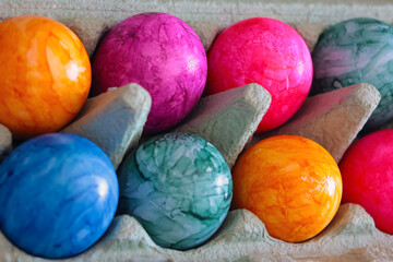 Colorful Easter Eggs in an egg carton.
