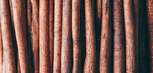 Background from cinnamon sticks. Long banner - 424782204