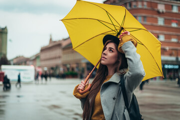 Woman with yellow umbrella out in the city