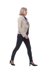 Portrait of casual woman walking straight and smiling