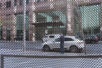 Metal outdoor privacy curtain. The curtain is made from small stainless steel rings woven together into a mesh curtain