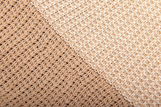 Knitted background. Knitted texture. A sample of knitting from wool. Knitting Pattern.