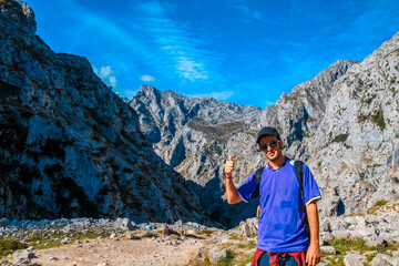 A young man on the trail in the Picos de Europa, on the Cares route. Asturias