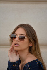 Close up fashion portrait of amazing young woman with perfect skin, full lips , blonde hair in stylish sunglasses