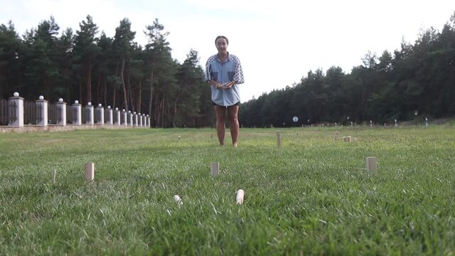 girl throws a stick in the viking chess game