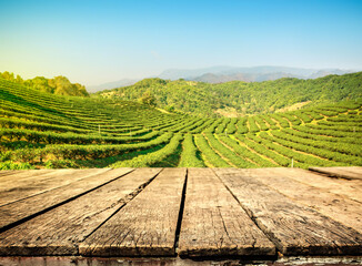Empty wooden old table and blur tea plantation background