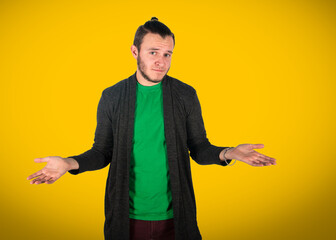 Gesture, bewilderment. The guy in a green T-shirt on a yellow 