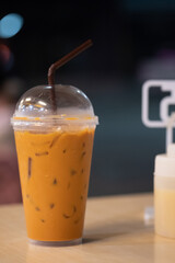 Iced Thai milk tea in takeaway glass