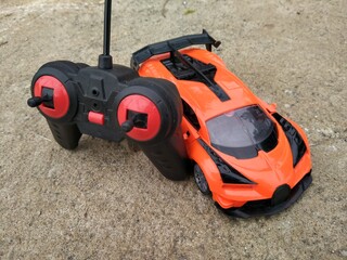 Jakarta, Indonesia - November 29, 2020 : Orange toy remote children's car on the street