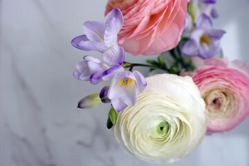 Beautiful bouquet with spring ranunculus and freesias
