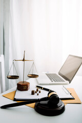 Justice and law concept.Male judge in a courtroom with the gavel, working with, computer and docking keyboard, eyeglasses, on table in morning light