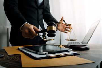 Business and lawyers discussing contract papers with brass scale on desk in office. Law, legal services, advice, justice and law concept picture with film grain effect