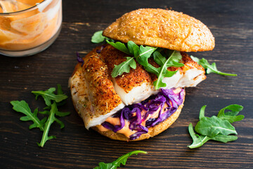 Blackened Fish Burger and Sriracha Mayo: A halibut fish sandwich with red cabbage and arugula on a...