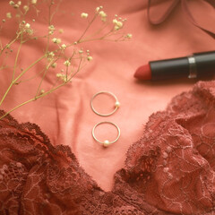 Lace bralette, red lipstick and silver rings. Selective focus.