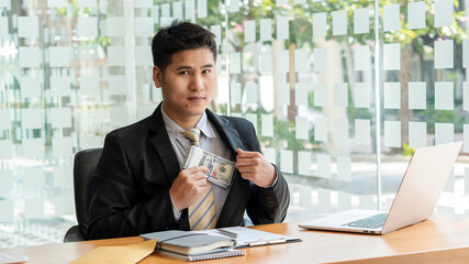 A corrupt businessman was offered money with a dollar bill in hand to pay an agreed bribe after a...