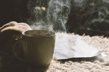 the concept of a cozy home, coffee book and plaid 