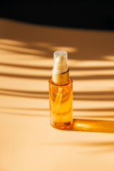 a bottle of cosmetics on a beige background