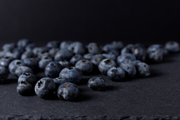 Healthy fruits. Blueberries and Raspberries over a black slate and dark background