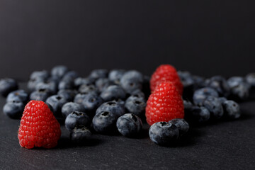 Front, Dark, Healthy fruits. Blueberries and Raspberries.