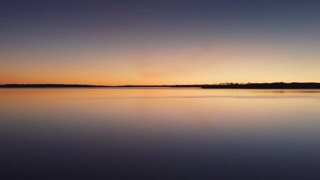 Drone Over Tranquil Waters At Sunset