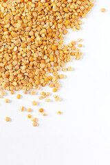 Yellow split peas on white in studio.