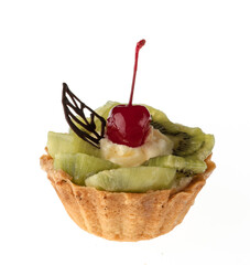 Dessert, cake with kiwi and cherries, on a white plate isolated