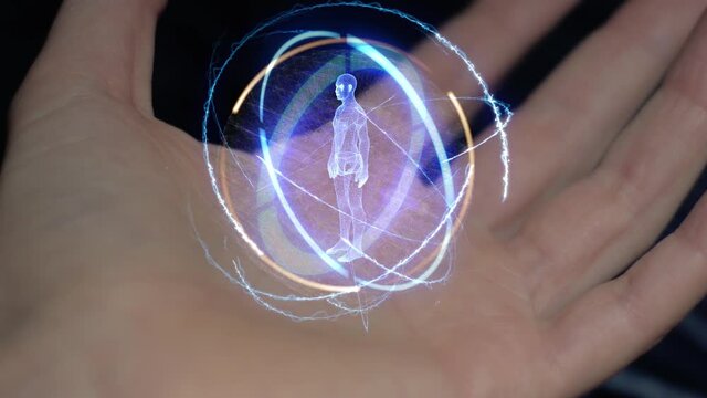 Male body in a round conceptual hologram on a female hand. Close-up of a hand on a black background with future holographic technology