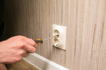 Screwdriver in hand and socket.