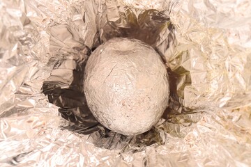 Brazilian Chocolate Easter egg (Ovo de Páscoa), wrapped in aluminium foil. Easter in Brazil concept.
