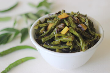 Stir fried beans with chopped coconut, green chillies, turmeric and curry leaves using coconut oil.