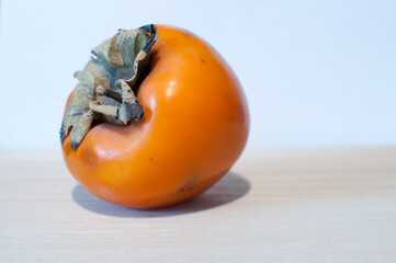 Ripe persimmon on white background. Background, texture, design.