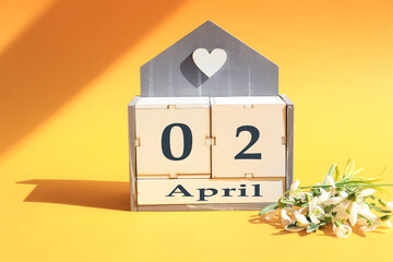 Calendar for April 2: cubes with the numbers 0 and 2, the name of the month of April in English, a...