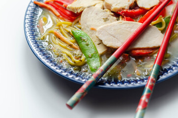 Chicken broth with ginger and black fungus mushrooms, high protein wheat noodles, sliced steamed chicken breast, julienne carrots, red peppers, and sugar snap peas