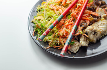 Cooked chicken breast pieces with egg noodles, carrots, and cabbage in a savory chow mein sauce