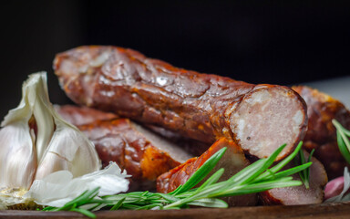 Traditional Polish juniper sausage on a wooden plate, luxury smoked product